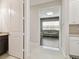 Hallway view into living room with grey sofa and hardwood floors at 2709 Coco Palm Cir, Wesley Chapel, FL 33543