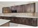 Modern kitchen showcasing dark wood cabinets, stylish backsplash and light countertops at 2709 Coco Palm Cir, Wesley Chapel, FL 33543