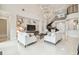 Elegant living room featuring a grand staircase, floral wall art, and comfortable sofas at 2709 Coco Palm Cir, Wesley Chapel, FL 33543