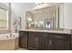 A main bathroom with dual vanities, granite countertops, and a soaking tub at 2709 Coco Palm Cir, Wesley Chapel, FL 33543