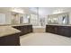 Main bathroom with dual vanities, soaking tub, and elegant finishes at 2709 Coco Palm Cir, Wesley Chapel, FL 33543