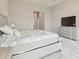 Main bedroom featuring neutral decor, tray ceiling, and stylish furnishings at 2709 Coco Palm Cir, Wesley Chapel, FL 33543