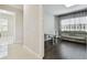Bright office space with desk, sofa, hardwood floors, and large window at 2709 Coco Palm Cir, Wesley Chapel, FL 33543