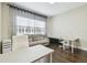 Bright office area with sofa, desk, and hardwood floors at 2709 Coco Palm Cir, Wesley Chapel, FL 33543