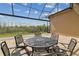 Outdoor dining area with seating for six with an extended screened-in patio at 2709 Coco Palm Cir, Wesley Chapel, FL 33543