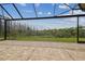 The covered patio has a beautiful view of the backyard and the pond beyond the treeline at 2709 Coco Palm Cir, Wesley Chapel, FL 33543