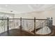 Elegant wrought iron staircase with dark wood flooring on landing at 2709 Coco Palm Cir, Wesley Chapel, FL 33543