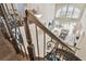 Overhead view of living room from a dark-wood and wrought iron staircase at 2709 Coco Palm Cir, Wesley Chapel, FL 33543
