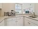 Wet bar featuring white cabinets and stainless steel coffee machine at 2709 Coco Palm Cir, Wesley Chapel, FL 33543