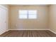 Neutral bedroom featuring wood-look flooring and a window for natural light at 6730 32Nd N Ave, St Petersburg, FL 33710