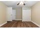 Bedroom with wood floors, fan, light walls, multiple closets and doorways at 6730 32Nd N Ave, St Petersburg, FL 33710