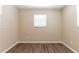 Empty room with wood floors, light walls, and a bright window at 6730 32Nd N Ave, St Petersburg, FL 33710