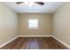 Bedroom with wood floors, fan, light walls, and a bright window at 6730 32Nd N Ave, St Petersburg, FL 33710