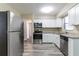 Modern kitchen with white cabinets, granite countertops, and stainless steel appliances providing an efficient design at 6730 32Nd N Ave, St Petersburg, FL 33710