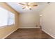 Cozy living space with wood-look floors, ceiling fan, and a large window that brightens the room at 6730 32Nd N Ave, St Petersburg, FL 33710
