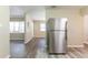 Open-concept living space with wood-look floors and natural light; stainless steel refrigerator on right at 6730 32Nd N Ave, St Petersburg, FL 33710