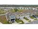 This aerial view showcases the neighborhood's community and nearby pond at 7617 Wallflower Trl, Wesley Chapel, FL 33545