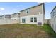 Large backyard featuring lush green grass and a vinyl fence for privacy at 7617 Wallflower Trl, Wesley Chapel, FL 33545