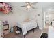 Bright bedroom with a bed, rainbow decor, and connected bathroom at 7617 Wallflower Trl, Wesley Chapel, FL 33545