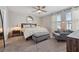 This bedroom includes a padded bench, comfortable lounge chair, and a large circular mirror at 7617 Wallflower Trl, Wesley Chapel, FL 33545