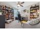 Comfortable home office with desk, bookshelf, couch, and natural light at 7617 Wallflower Trl, Wesley Chapel, FL 33545