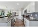 Bright kitchen featuring stainless steel appliances, a central island, and streamlined cabinetry at 7617 Wallflower Trl, Wesley Chapel, FL 33545