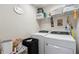This spacious laundry room offers a washer and dryer set and ample storage at 7617 Wallflower Trl, Wesley Chapel, FL 33545