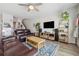 Bright living room featuring stylish furniture, decor, and easy access to the staircase at 7617 Wallflower Trl, Wesley Chapel, FL 33545