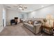 Upstairs living room with comfortable seating, a ceiling fan, and a work space at 7617 Wallflower Trl, Wesley Chapel, FL 33545