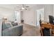 Upstairs living area with sofa, desk, and a view into the hallway of the home at 7617 Wallflower Trl, Wesley Chapel, FL 33545