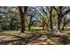Scenic backyard with mature trees providing shade and privacy, creating a tranquil and inviting outdoor space at 18218 Railroad Rd, Spring Hill, FL 34610