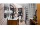 Cozy bathroom featuring wood paneling, glass block shower, and neutral fixtures at 18218 Railroad Rd, Spring Hill, FL 34610