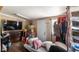 Spacious bedroom with hardwood floors, a clothing rack, and a door to the exterior at 18218 Railroad Rd, Spring Hill, FL 34610
