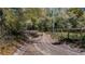 Dirt driveway lined with fencing and mature trees at 18218 Railroad Rd, Spring Hill, FL 34610