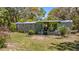 Quaint mobile home featuring a covered porch, offering a cozy and inviting outdoor space at 18218 Railroad Rd, Spring Hill, FL 34610