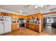 Kitchen with wooden cabinets, modern appliances, and wooden flooring at 18218 Railroad Rd, Spring Hill, FL 34610