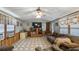 Comfortable living room with neutral colors, tile floors, and a large TV at 18218 Railroad Rd, Spring Hill, FL 34610