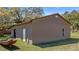 Exterior shot of a tan colored storage shed with a side door and boat at 18218 Railroad Rd, Spring Hill, FL 34610