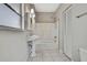 Bathroom featuring a pedestal sink, shower and built-in shelves at 2435 Riverview Blvd, Bradenton, FL 34205