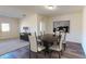 Dining room featuring luxury vinyl plank flooring, contemporary artwork, and an adjacent living area at 36137 Canelli Way, Dade City, FL 33523