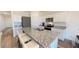 Modern kitchen with granite counters, stainless steel appliances, and a large island with bar seating at 36137 Canelli Way, Dade City, FL 33523