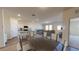 Open-concept living and kitchen area with lots of natural light, and a dining table at 36137 Canelli Way, Dade City, FL 33523