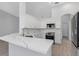 Well-lit kitchen featuring white cabinetry, sleek stainless-steel appliances, and marbled countertops at 6741 64Th E Ter, Bradenton, FL 34203