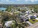 Aerial view of the property highlighting the fully fenced yard, the roof, and neighborhood lake views at 4907 21St W Ave, Bradenton, FL 34209