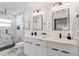 Stylish bathroom with double sinks, modern lighting, and a glass-enclosed shower at 4907 21St W Ave, Bradenton, FL 34209