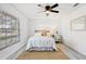Bright bedroom featuring a ceiling fan, neutral decor, a natural rug, and windows for ample lighting at 4907 21St W Ave, Bradenton, FL 34209