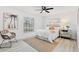 Cozy bedroom featuring a natural rug, neutral decor, a ceiling fan, and two windows for ample lighting at 4907 21St W Ave, Bradenton, FL 34209