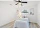 Bright bedroom featuring neutral decor, a ceiling fan, and two windows for ample natural lighting at 4907 21St W Ave, Bradenton, FL 34209