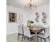 Bright dining room with modern lighting fixture, contemporary artwork, and seating for six at 4907 21St W Ave, Bradenton, FL 34209