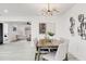 Stylish dining area with modern lighting and artwork, and a view into the living room at 4907 21St W Ave, Bradenton, FL 34209